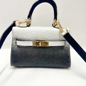 SIYL Ostrich Mini Bag — two-tone black and white ostrich leather front view with gold clasp
